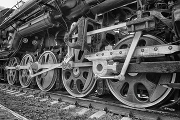 Fototapeta na wymiar wheels of an ancient locomotive close-up, retro vehicle, black and white photo