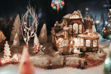 christmas time, miniature of houses and people, winter and snow at night, xmas houses decorated with lights 