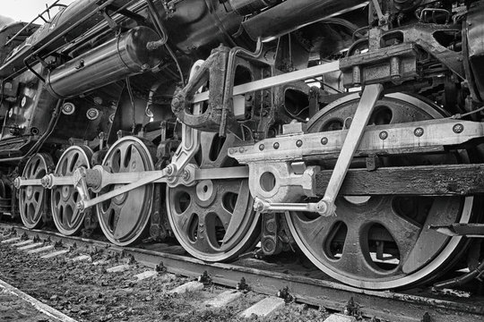 wheels of an ancient locomotive close-up, retro vehicle, black and white photo