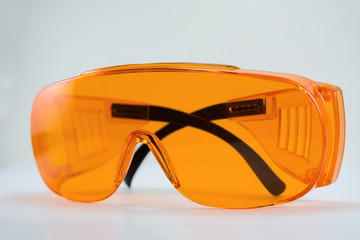 orange protective glasses in dentistry for work with UV lamp, glasses for light seals