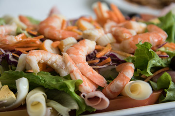 Fresh salad with shrimp, red cabbage and carrots .