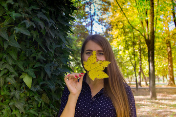 Beautiful girl in autumn leaves