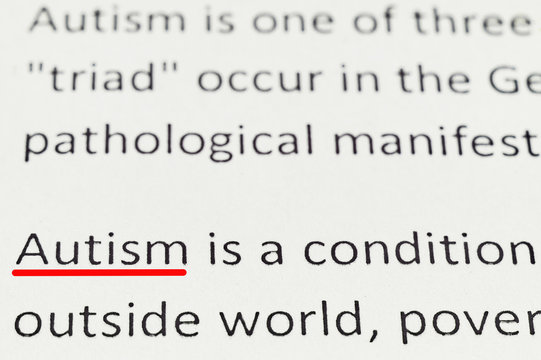 macro photography of the word autism from the newspaper