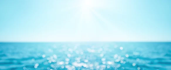 Foto auf Glas Beautiful Blur defocused blue sea background with sun rays and bokeh. Landscape of tropical summer. Summer vacation concept © Tatyana Sidyukova
