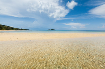Fototapeta na wymiar Deserted beach at Prek Svay on Koh Rong island, Cambodia with clear blue water and golden sand.