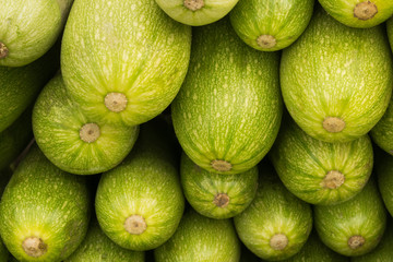 Zucchini for salad lie on the window of a market, store, supermarket