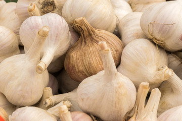 The heads of garlic lie on the window of a market, store, supermarket