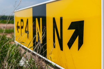 Airport taxiway sign. Directional sign markings by the runway in a commercial airport.