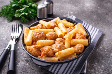 Pasta with meatballs in tomato sauce.