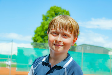 child looks happy and satisfied after the tennis match