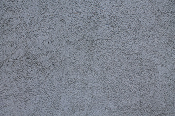 Closeup of a gray concrete wall. Natural stucco patterns.