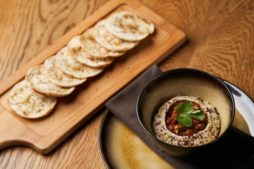 Baba ganoush hummus with eggplant on wooden table background.