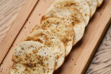 Matzah - Jewish traditional Passover bread on wooden table.