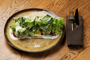 Dietary chicken salad with avocado, cucumber, arugula, cherry tomatoes