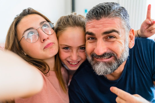Selfie of happy father with two daughters