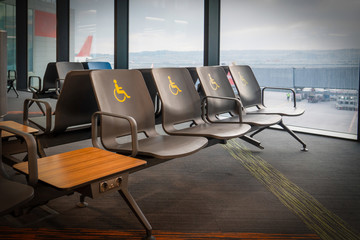 Empty disabled seats at an airport in the waiting area before boarding.