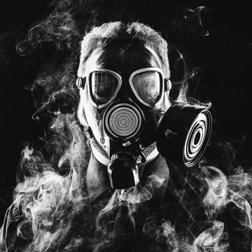a man in a suit gas mask and smoke