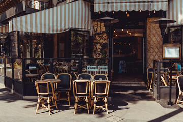 Cozy street with tables of  cafe in Paris, France - obrazy, fototapety, plakaty
