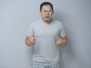 Asian Man Pointing Himself with Unhappy Expression as if he confused to be accused