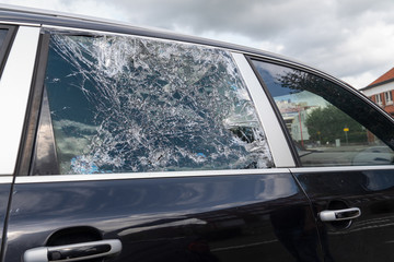Closeup picture of black stolen damage car broken glass windows