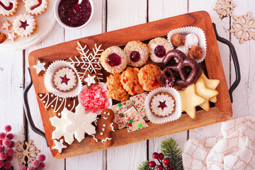 Tray of Christmas cookies. Top view table scene over a white wood background. Holiday baking concept.