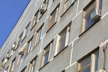 A dilapidated gray building of an old factory of the last century