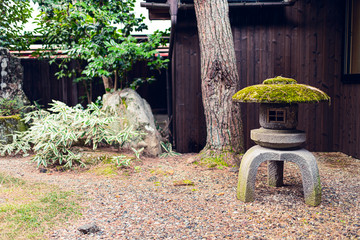 Traditional spring Japanese garden in Japan with small inside indoor with gravel stone rocks and...