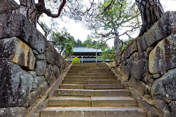 Takayama, Japan Higashiyama walking course in Gifu during day with stone steps entrance to architecture of Soyuji temple