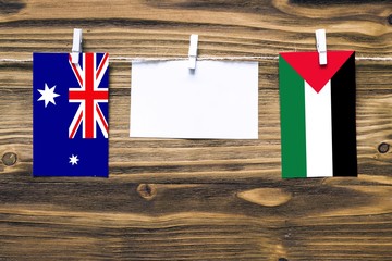 Hanging flags of Heard and Mcdonald Islands and Palestine attached to rope with clothes pins with...