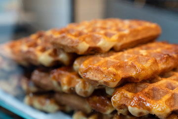 Homemade Belgian waffles with honey background