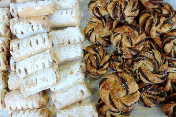 Small rolls with poppy seeds and powdered sugar on the market. The market in Jerusalem.