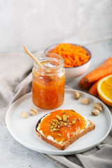 Carrot Jam with orange juice on a gray background