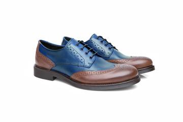 Pair of male blue and brown leather shoes on white background, isolated product, top view.
