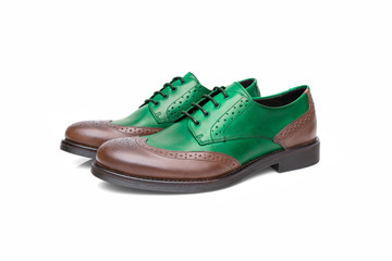 Pair of male green and brown leather shoes on white background, isolated product.