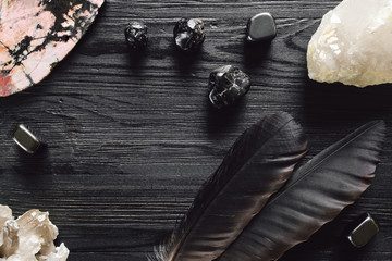 Crystals and Feathers on Black Stained Wood - obrazy, fototapety, plakaty