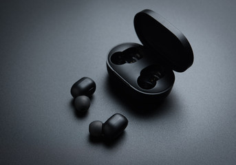 Black wireless earphones in-ear with charging case