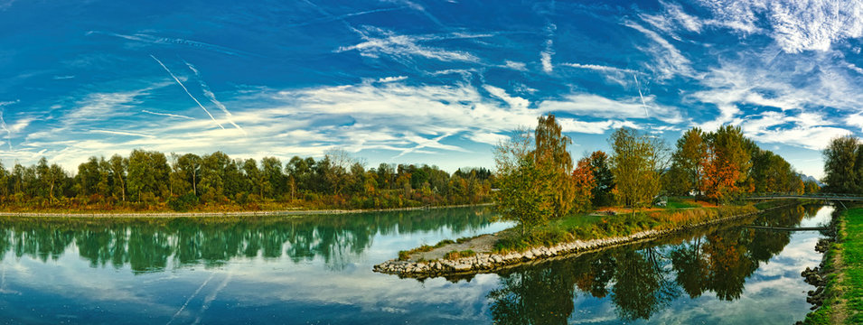 The river Mangfall flows into the river Inn, Panorama of landscape, near Rosenheim in Upper Bavaria, trees in autumn colors on the banks
