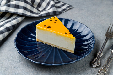 Cheesecake passion fruit on grey table