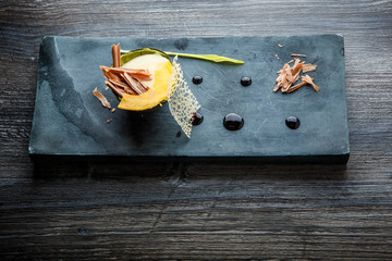 exquisite restaurant dessert of baked avocado decorated with chocolate