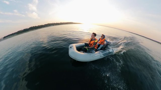 River is being crossed by two men in the inflatable boat