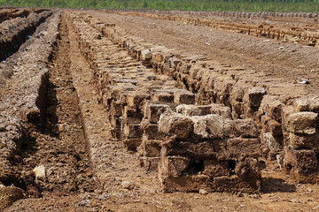 Pile of stacked bog peat turf briquette