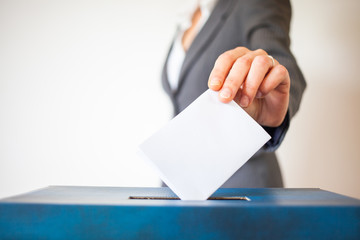 elections - The hand of woman putting her vote in the ballot box