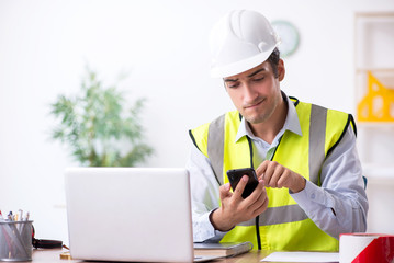 Young male architect working in the office