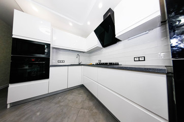 interior of a small modern white kitchen with built-in appliances.