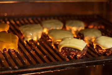Hamburger with melted cheese  on the grill