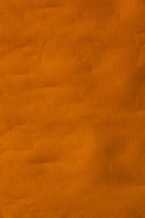 Real orange canvas with wrinkles as a background.