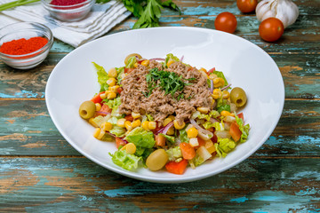 Tuna and vegetable salad on wooden table