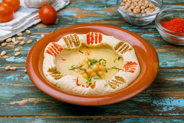 Traditional homemade hummus on wooden table