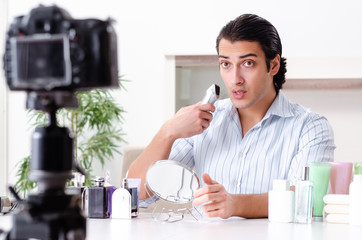 Young handsome man recording his blog in hygiene concept