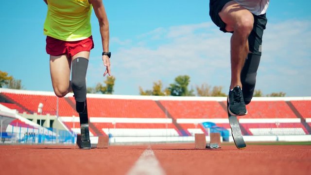 Running start held by two male paralympians